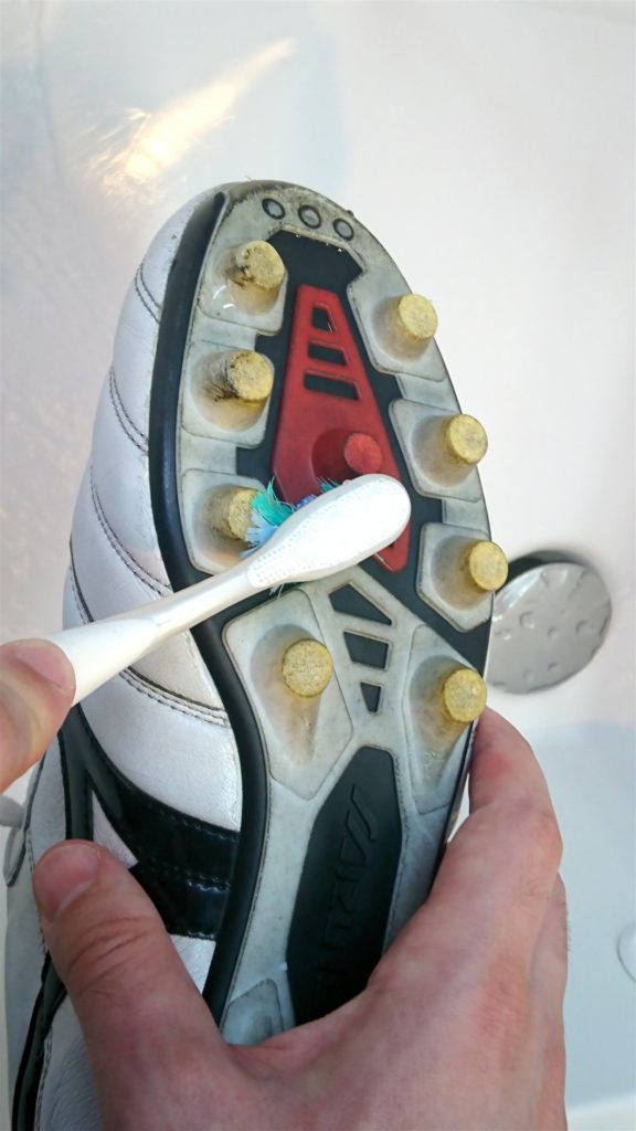 cleaning your football boots with a toothbrush